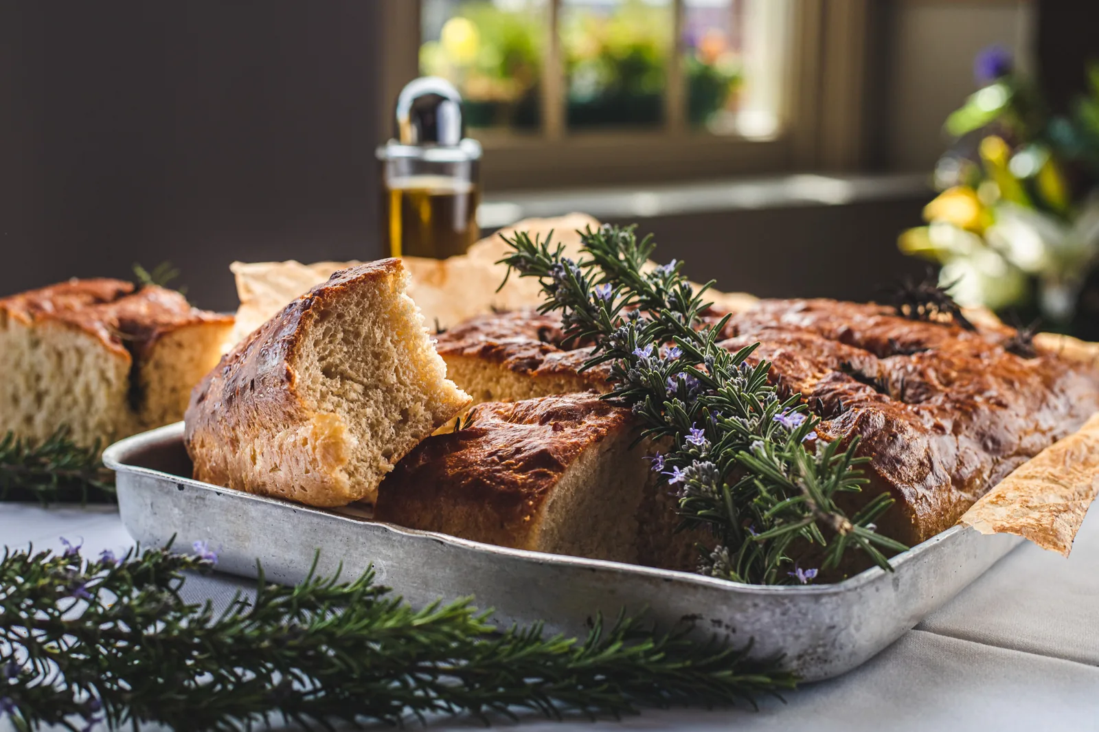 A tray of focaccia fresh from the oven at Ennios, scattered with rosemary and sea salt